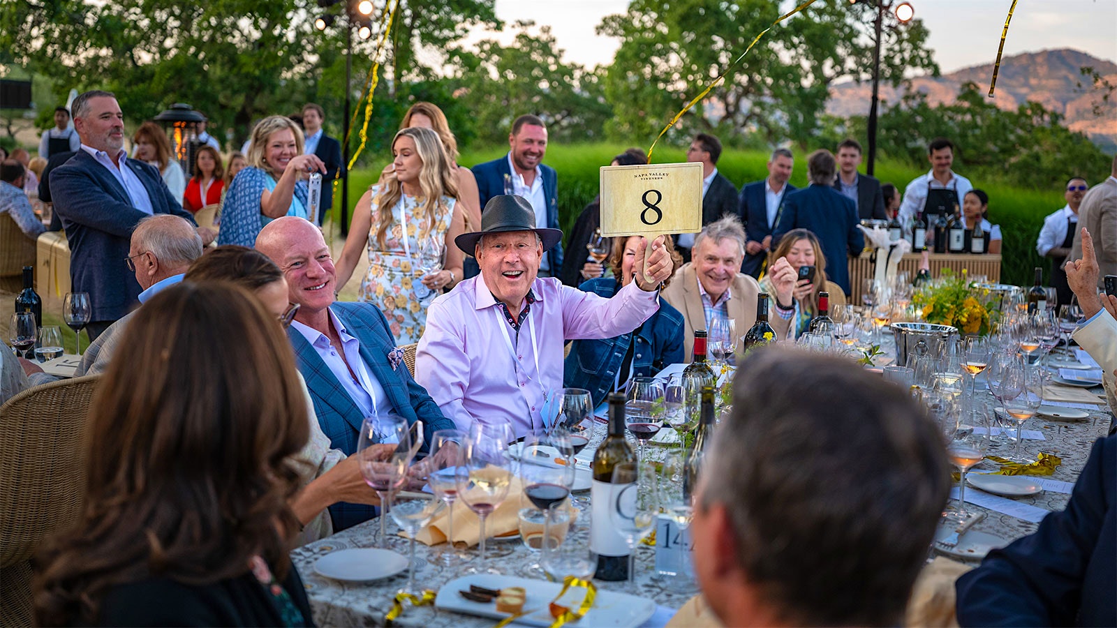 Mark Pulido enjoying the Auction Napa Valley live auction action with a table full of friends