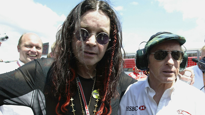 British rock star Ozzy Osbourne chats with Scottish race car driver Jackie Stewart of Jaguar before the Formula One Canadian Grand Prix at the Circuit Gilles-Villeneuve, on June 15, 2003 in Montreal, Canada.