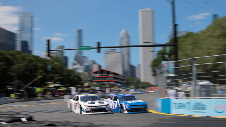 Kyle Larson, driver of the #17 HendrickCars.com Chevrolet, and Shane Van Gisbergen, driver of the #97 WeatherTech Chevrolet, race during the NASCAR Xfinity Series The Loop 110 at Chicago Street Course on July 06, 2024 in Chicago, Illinois.