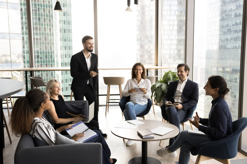 group of professionals engaged in a strategic icebreaker during a meeting