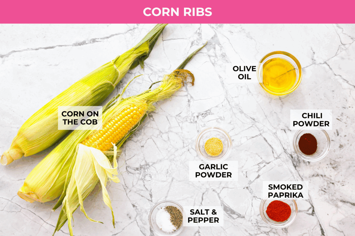 I had to try these viral Corn Ribs, and now I totally get the hype! They're fun, handheld, and smothered in creamy, zesty Mexican street corn flavor. Make a batch to share... or don’t. I won’t judge. Overhead shot of labeled corn rib ingredients.