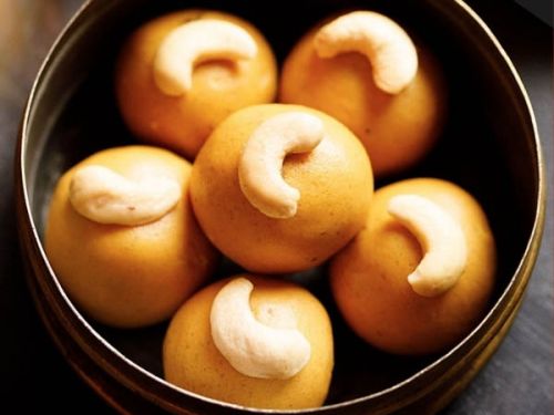 besan ladoo in a brass bowl.