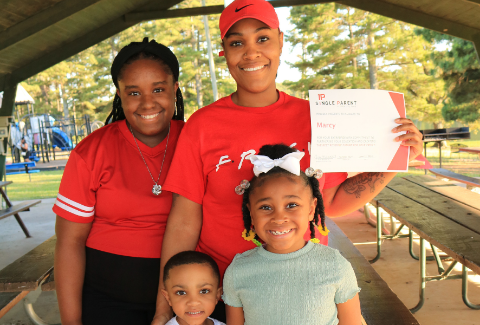 ASPSF Recipient Marcy with her 3 kids accepting an ASPSF scholarship