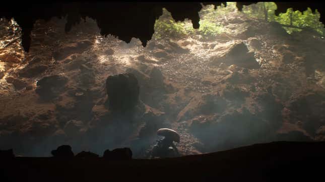 A Xenomorph out of the entrance of a cave, lit by the sun.