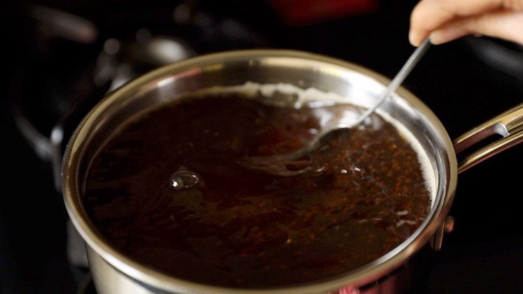stirring black tea steeped in water.