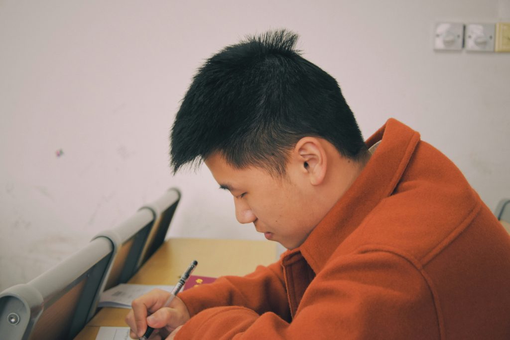 Young man writing