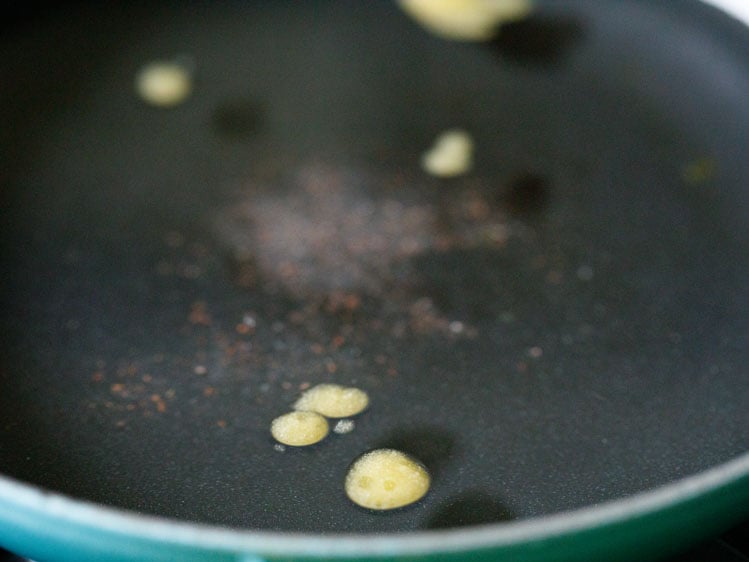 a pan having water, ghee and salt. 