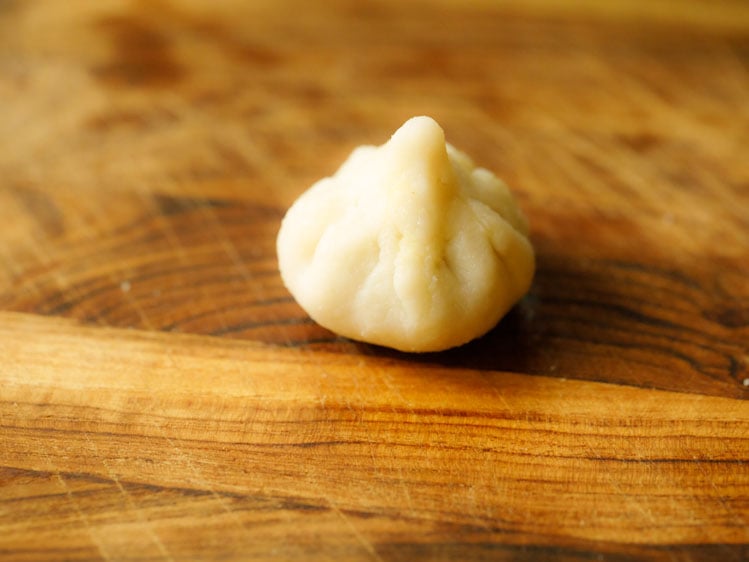 edges joined at the center and modak is shaped. 