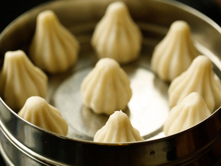 modak placed in a greased pan. 