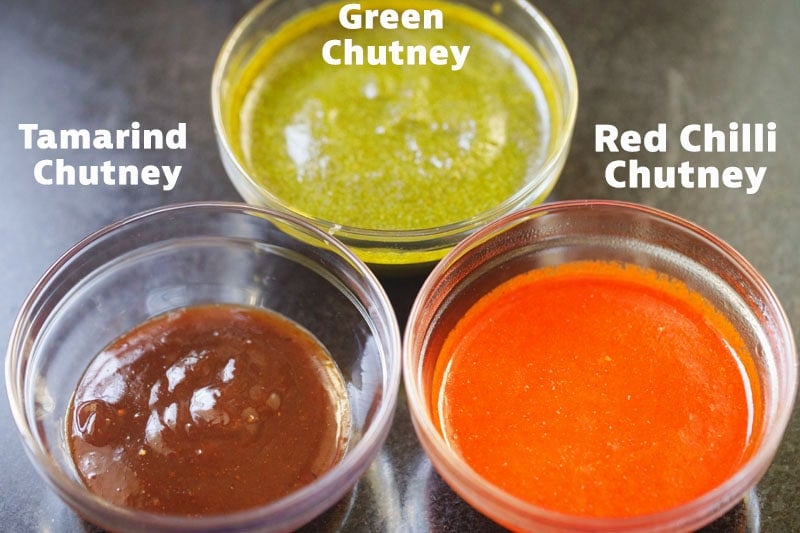 green, tamarind and red chutney in bowls. 