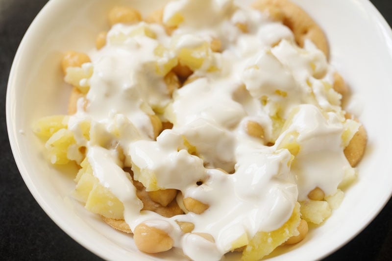 beaten curd on potatoes and chickpeas. 
