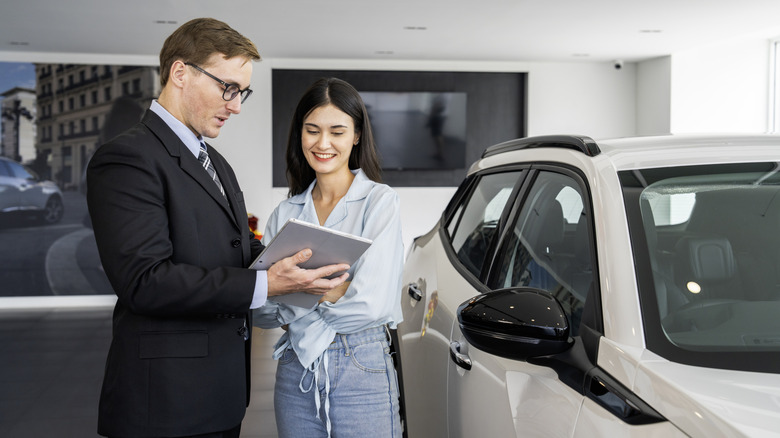 A happy women discussing a new car purchase