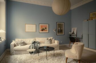A small apartment with a sky-blue living room and a modern kitchen