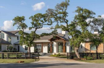 A stunning ranch style home surrounded by oak trees in Texas Hill Country