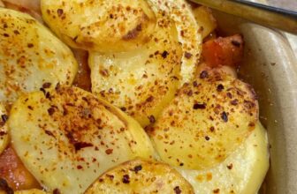 A tasty vegetable packed bake with crispy sliced potatoes on top.