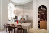 A contemporary home with a stainless steel kitchen and an arched coffee corner
