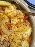 A tasty vegetable packed bake with crispy sliced potatoes on top.